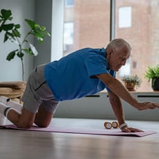 an elderly man exercising on a yoga mat