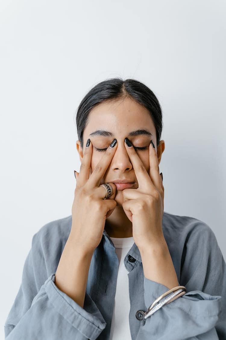 woman doing facial massage on her facial skin